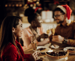 happy-woman-drinking-champagne-while-celebrating-christmas-with-her-friends-home